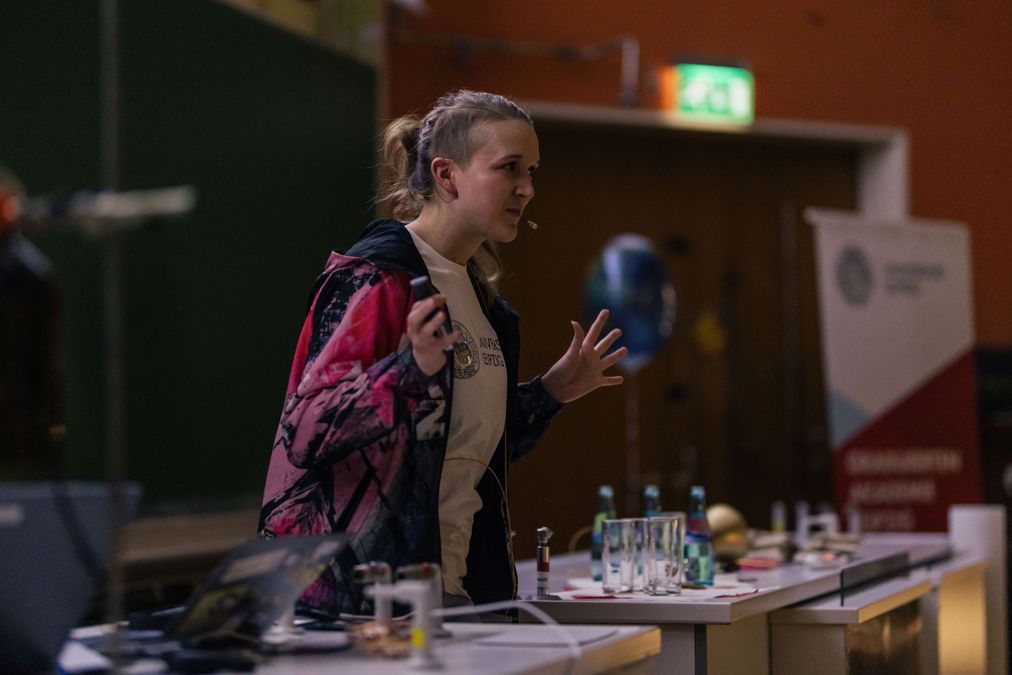 enlarge the image: Woman speaks to audience